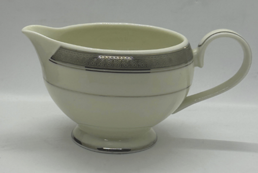 A white Mikasa Palatial Platinum fine china creamer with platinum trim.