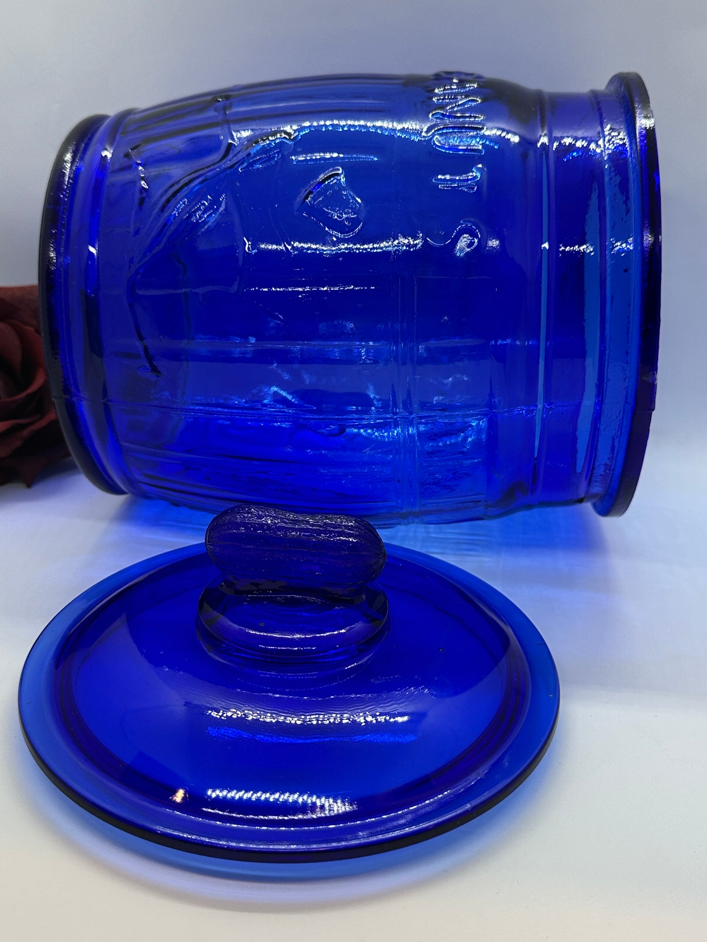 Blue glass jar with a matching blue lid on a white background