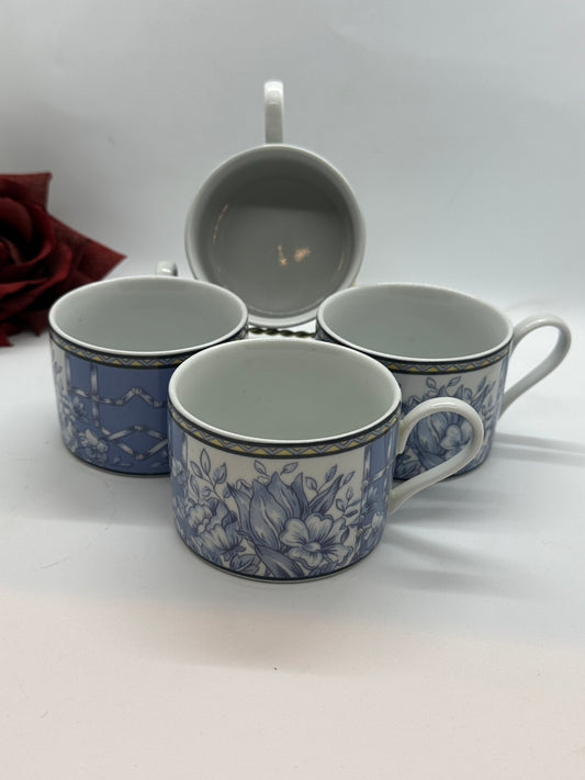 A set of four Coventry Palace Garden Porcelain Mugs with blue floral designs on a white background, displayed against a neutral backdrop with a shadow.