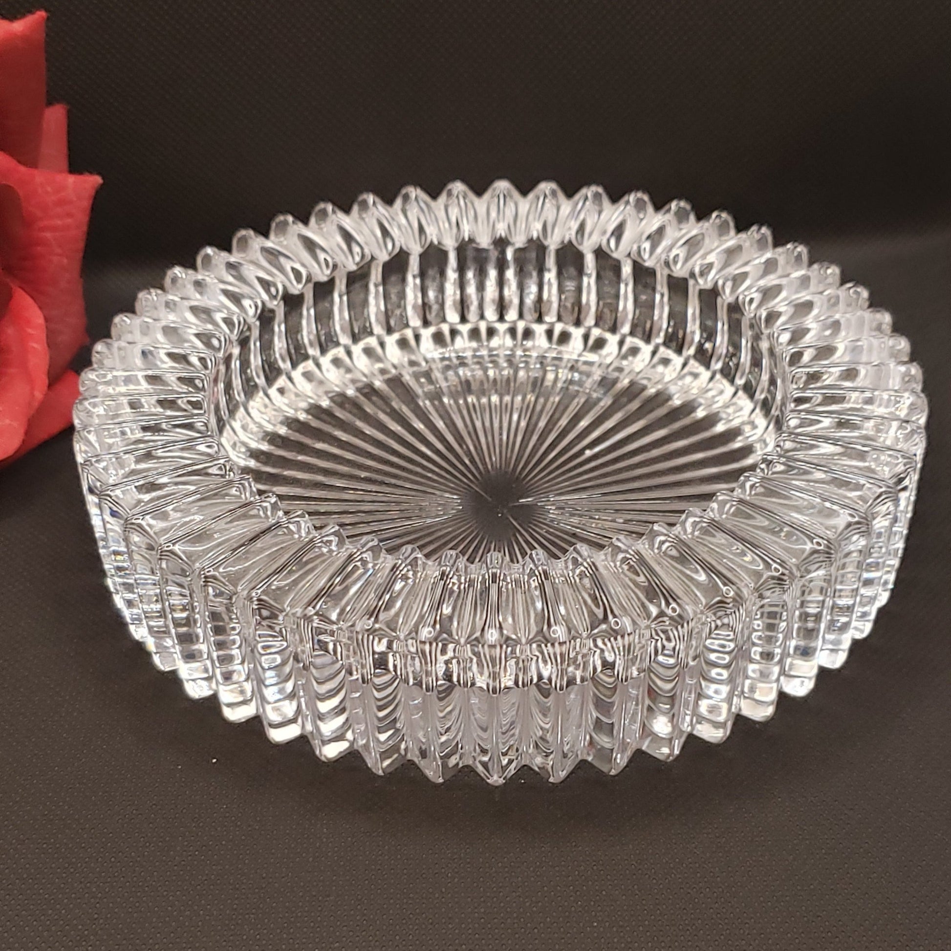 A clear, diamond-patterned crystal coaster.