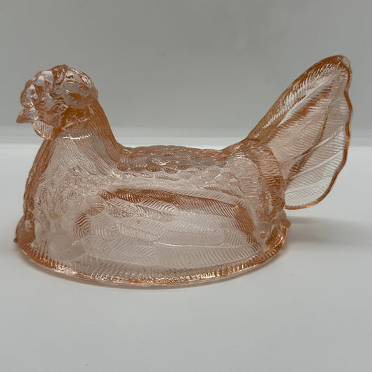 Decorative glass hen item with intricate design.