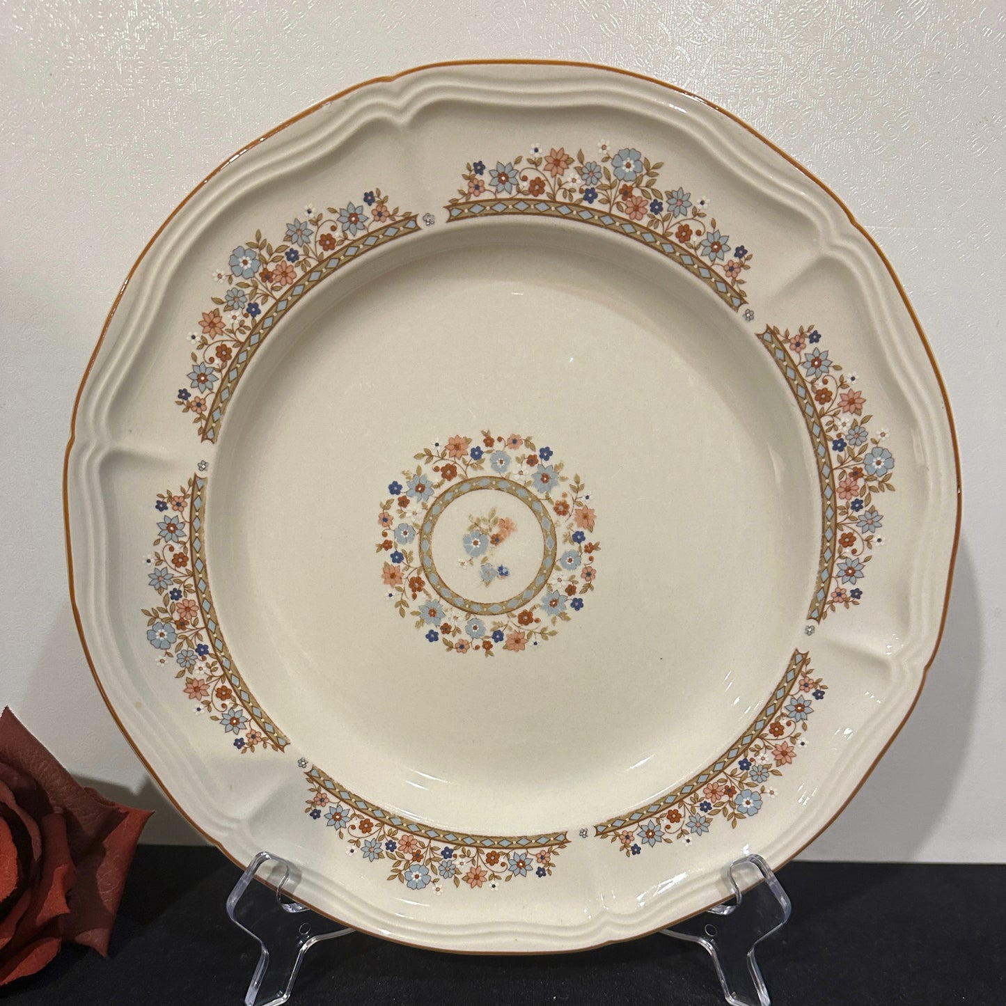 Decorative stoneware plate with floral patterns on a white background
